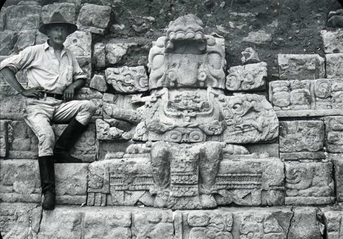 #4 George Gordon sits next to a figure seated on a throne on the Hieroglyphic Stairway, Copan, Honduras, 1900.
