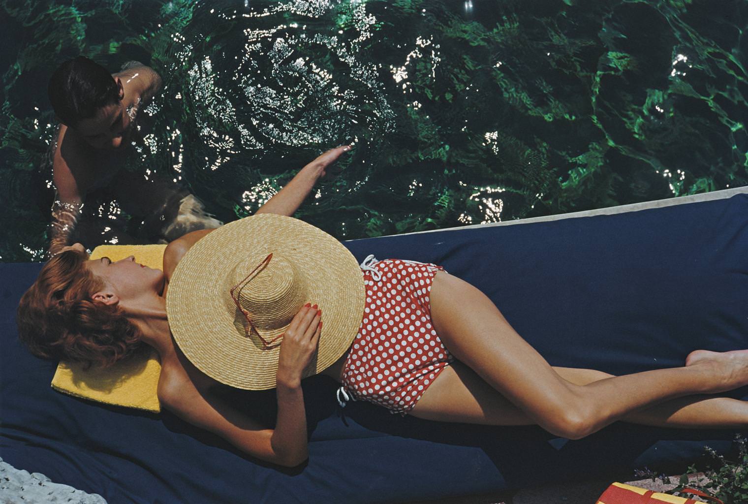#2 Lillian Hanson relaxes by the swimming pool at the Bürgenstock Estate, Lake Lucerne, Switzerland, 1955.