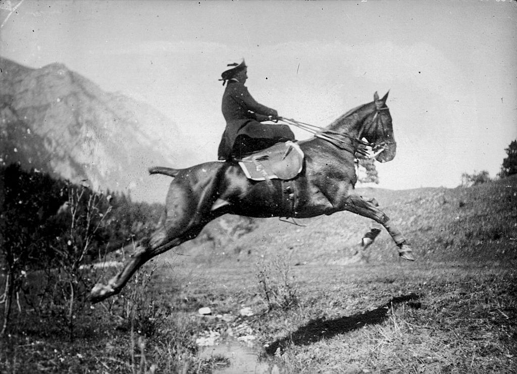 #20 Princess Marie of Romania jumps a horse over a very shallow creek, early 20th century.