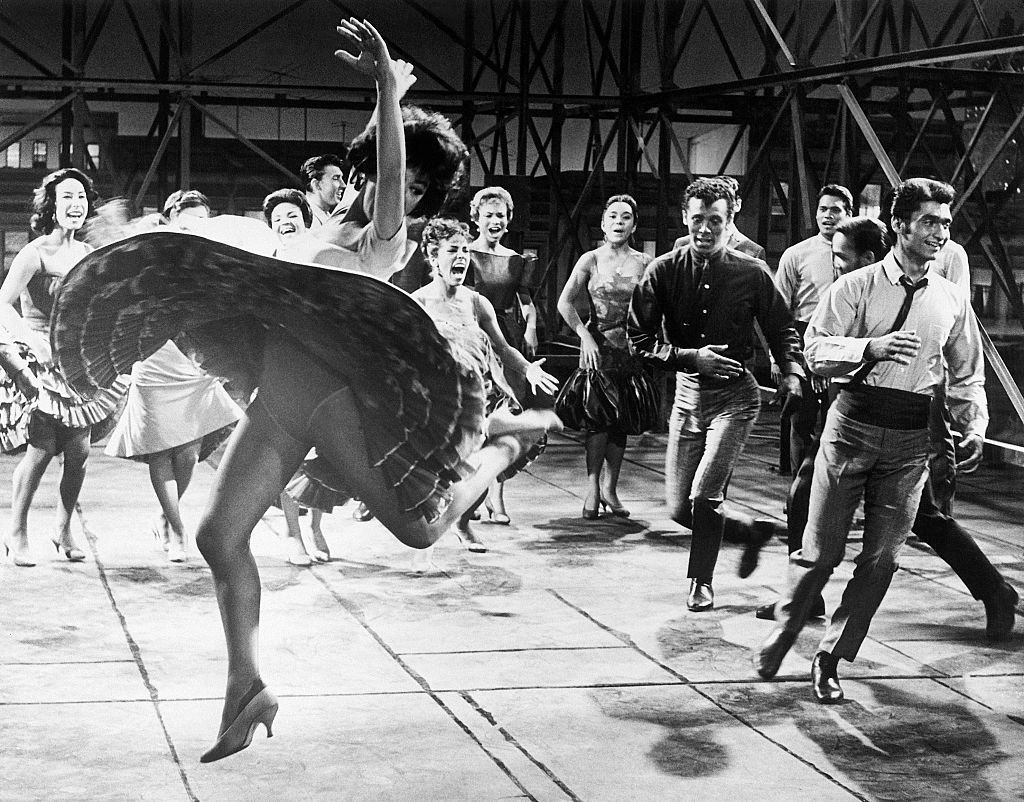 #54 Rita Moreno dancing with cast of West Side Story, 1961.
