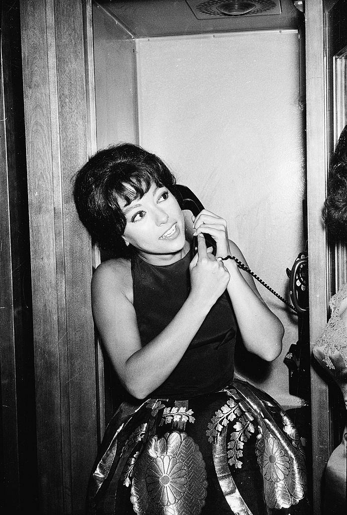 #61 Rita Moreno speaks on the telephone after winning the ‘Actress In a Supporting Role’ award for the film ‘Westside Story’, 1962.