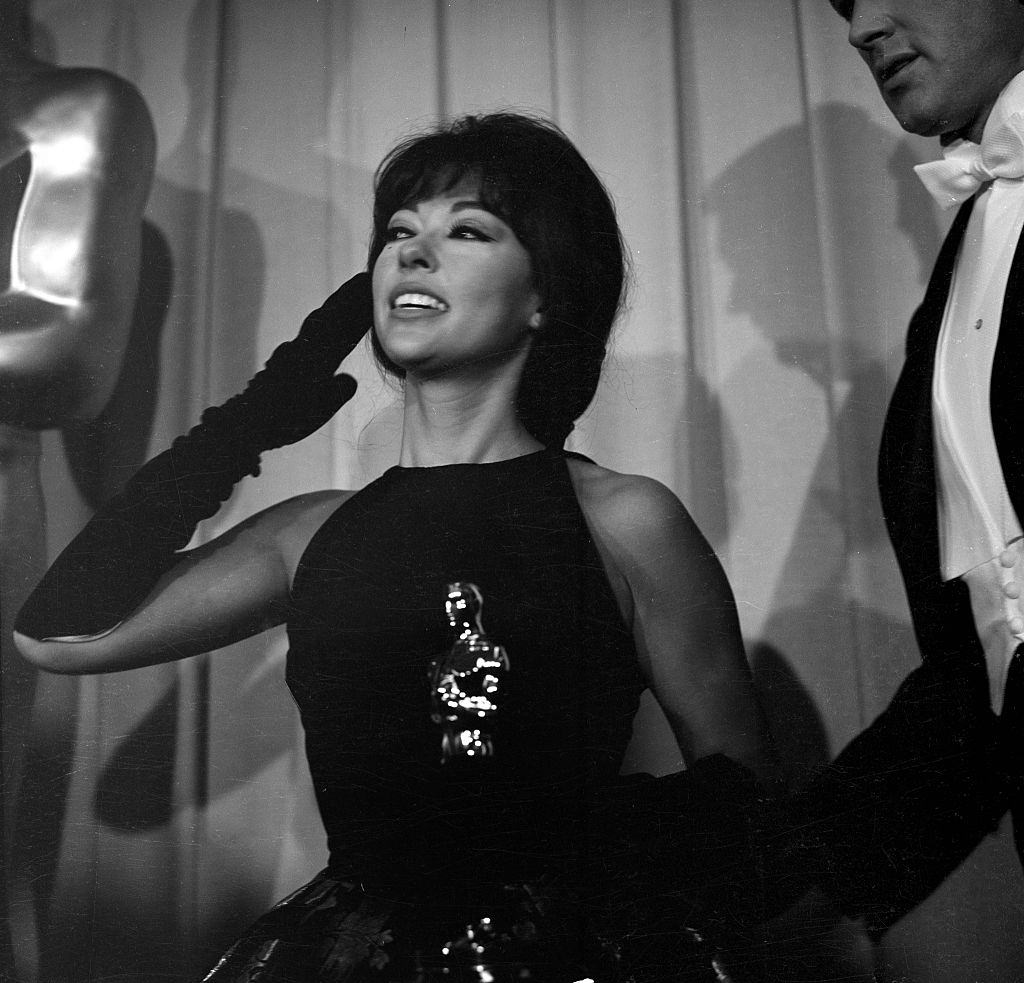 #65 Rita Moreno holds her Oscar during the Academy Awards after winning for ‘West Side Story’ in Los Angeles, 1962.