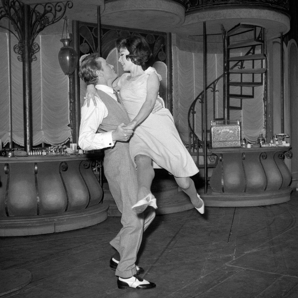 #69 Rita Moreno is swept off her feet by Gary Miller as they rehearse a tango at the Lyric Theatre for a scene in the musical ‘She Loves Me’, 1964.