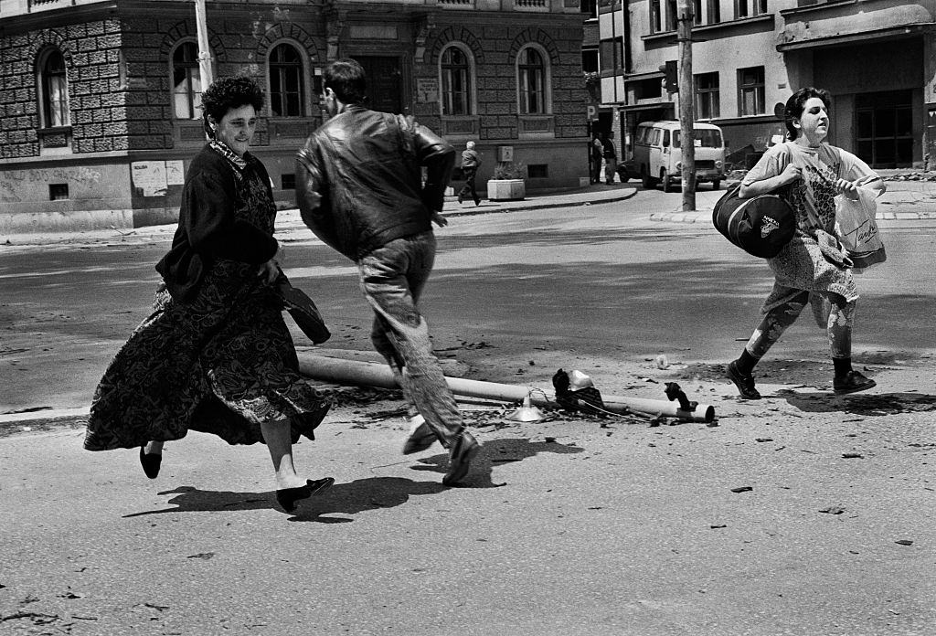 People run for their lives across ‘Sniper Alley’ under the sights of Serb gunmen during the siege of Sarajevo, 1992.