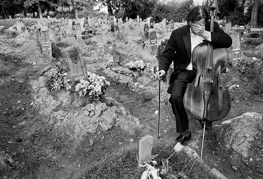 Celloist Vedran Smalovic breaks down in tears after playing a requiem to a dead friend in Hero’s Cemetery, where Bosnian fighters were buried during the siege of Sarajevo, 1992.