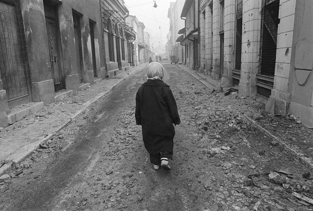 A 10-year-old Muslim boy, walks in the street. He survives in Sarajevo’s Old Town.