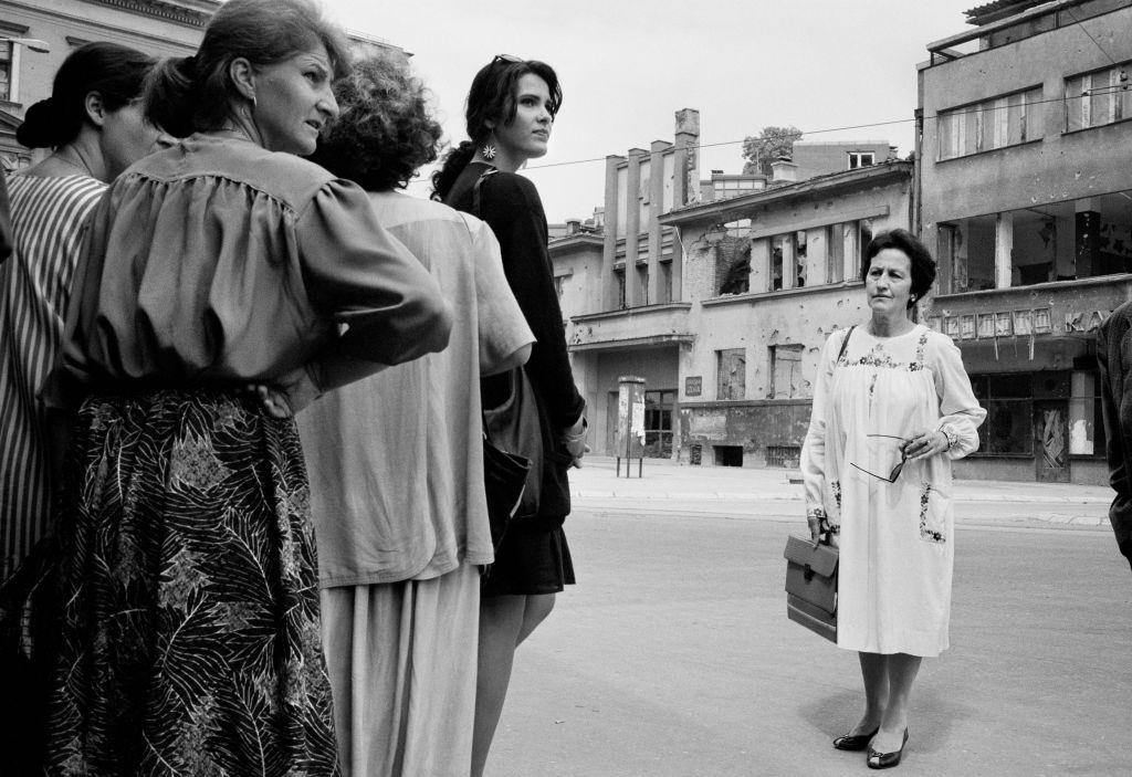 Women wait for the shooting to stop before running across ‘Sniper Alley’ during the siege of Sarajevo in 1995.