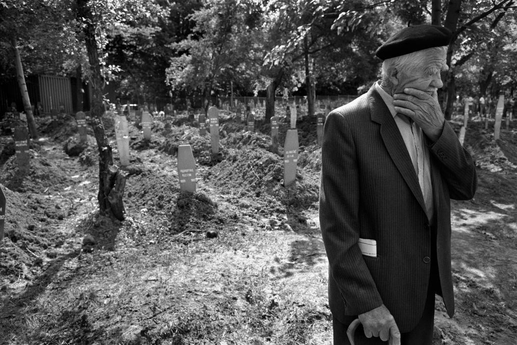 A man deep in thought in a Sarajevo cemetery, April 1994.