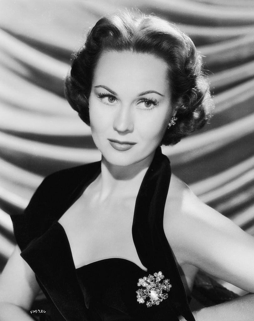 #34 Virginia Mayo in a black, halter-neck top, 1955.