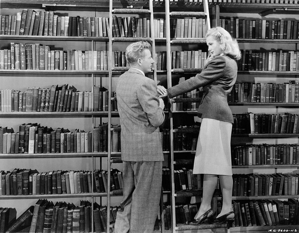 #73 Virginia Mayo and Danny Kaye in a library in a scene from the movie ‘Wonder Man’, 1945.