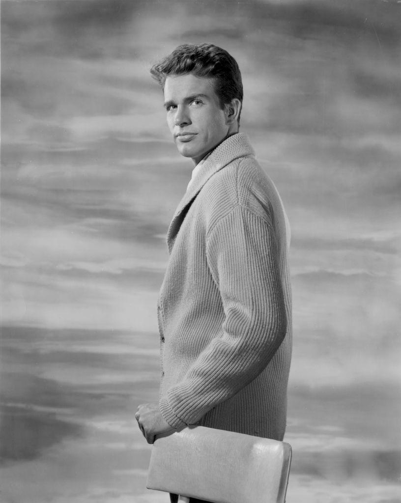 #11 Warren Beatty in a photo studio, with a hand on a chair’s back, 1950s.
