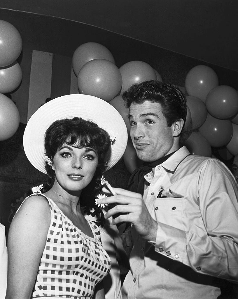 #25 Warren Beatty with English actress and fiancee Joan Collins at a Hollywood charity event.