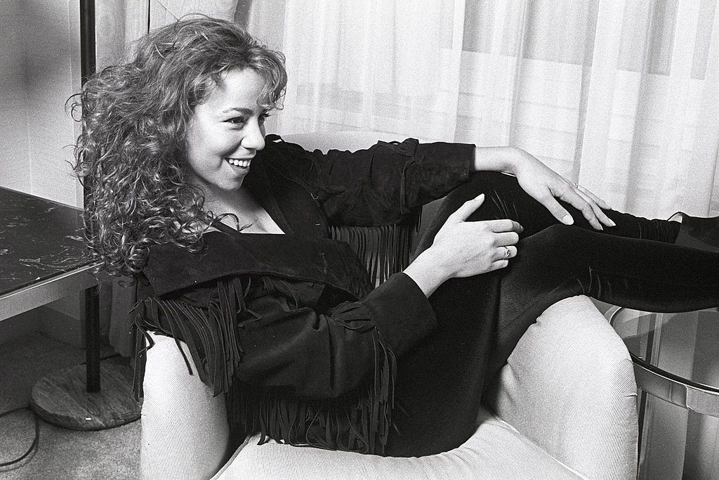 #15 Mariah Carey posing on the sofa, 1991.