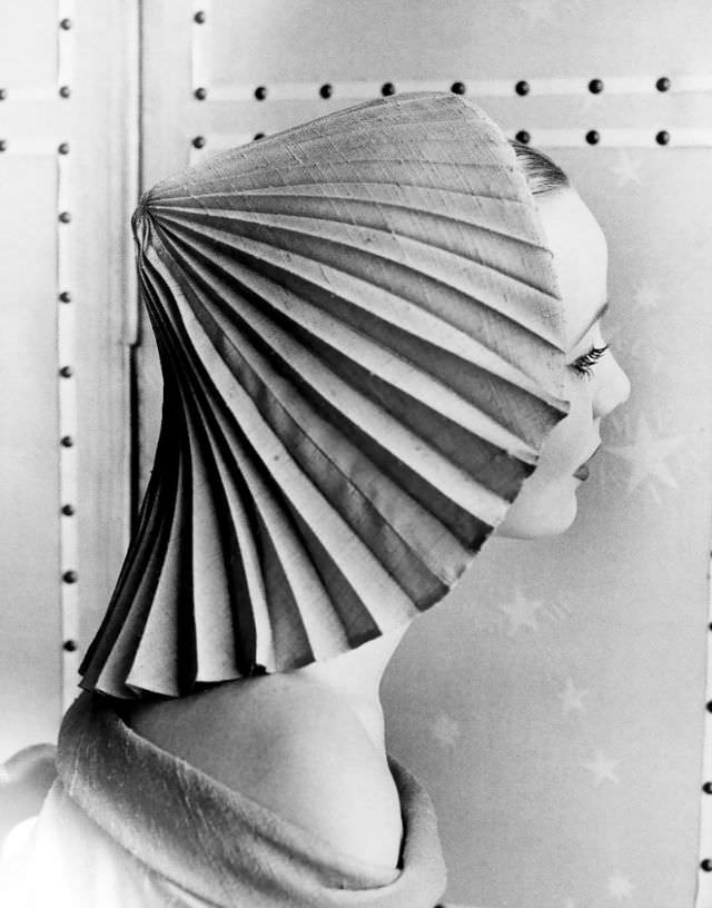 #10 Model in pleated hat by Elsa Schiaparelli, photo by Regina Relang, Paris, 1951