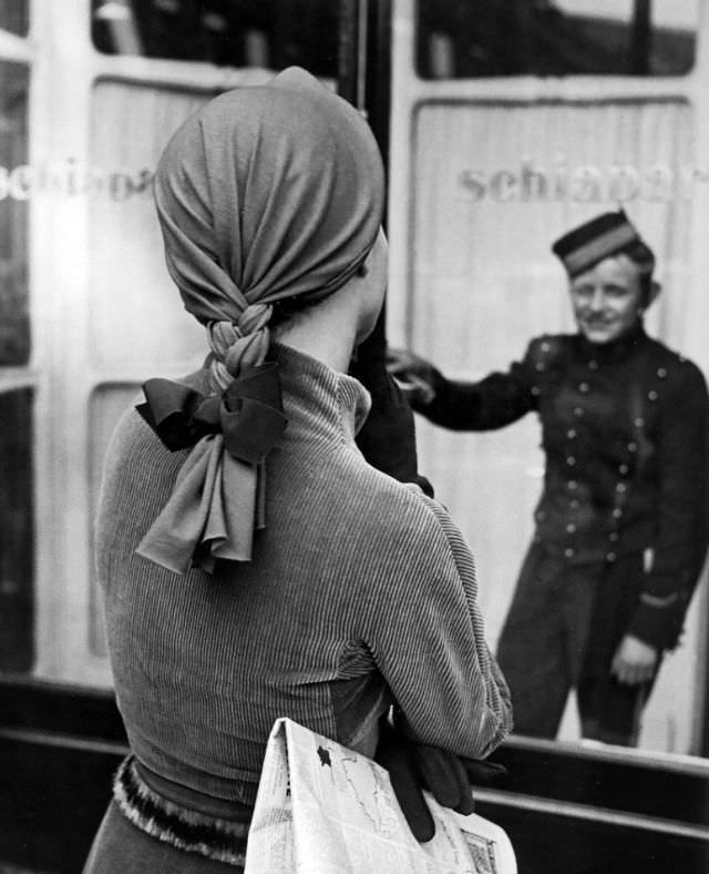 #11 Model in suit and a whimsical cap with braid by Elsa Schiaparelli, photo by Regina Relang outside Schiaparelli’s store, Paris, 1951