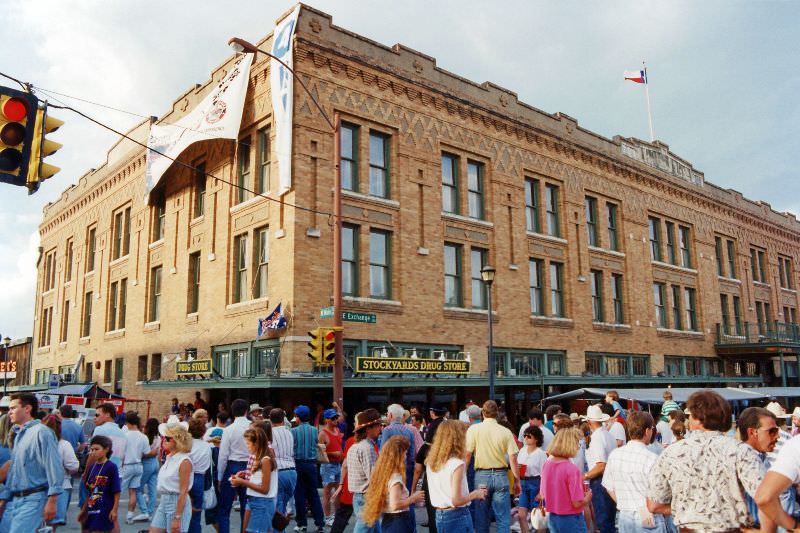 #7 Crowds attending the festival in the Fort Worth Stockyards pass by the hotel, on the corner of Main Street and Exchange Avenue, June 1993