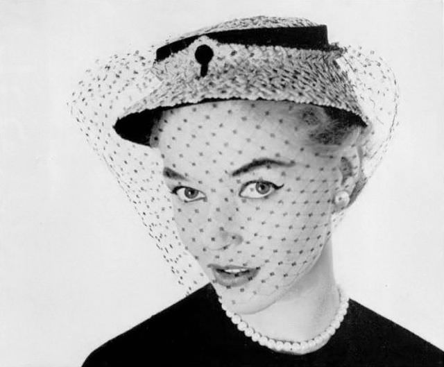 #13 Joan Olson in small fine straw and black velvet cloche with silk voilette by Janette Columbier, 1953
