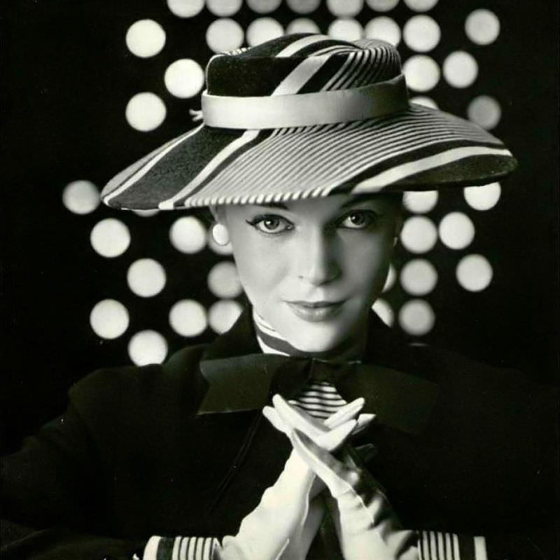 #16 Joan Olson in striped gray and white straw hat worn with matching jacket by Jean Barthet, 1953