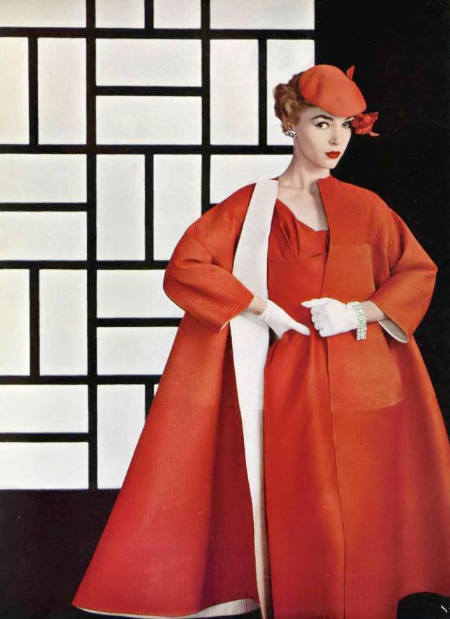 #22 Joan Olson in dinner ensemble, coat is reversible red and white raw silk matelasse, quilting worked in both directions, worn over red silk dress, by Lanvin-Castillo, 1954