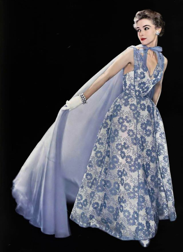 #23 Joan Olson in lilac organdy print evening dress with sheer organdy cape by Jean Dessès, bracelet by Vendôme, 1954