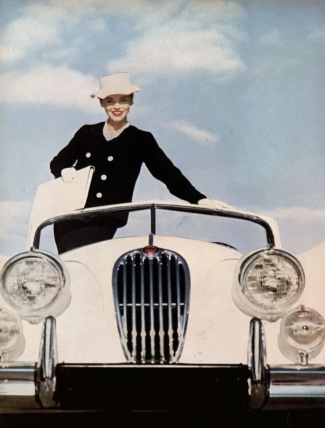 #30 Joan Olson in black flannel sheath dress and double-breasted jacket by Donald Brooks for Darbury, 1957