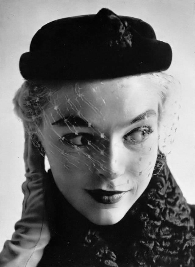 #6 Joan Olson in taupe little cap with honey-colored voilette by Christian Dior, 1952