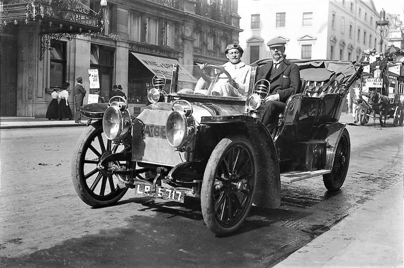 #9 London. William Cochrane and his driver are seen parked across from the Carlton Hotel