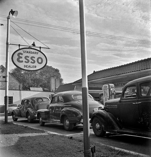 #15 Morning of July 21st, the last day before stricter gas rationing went into effect, cars were parked in front of gas stations, Washington, D.C., 1942