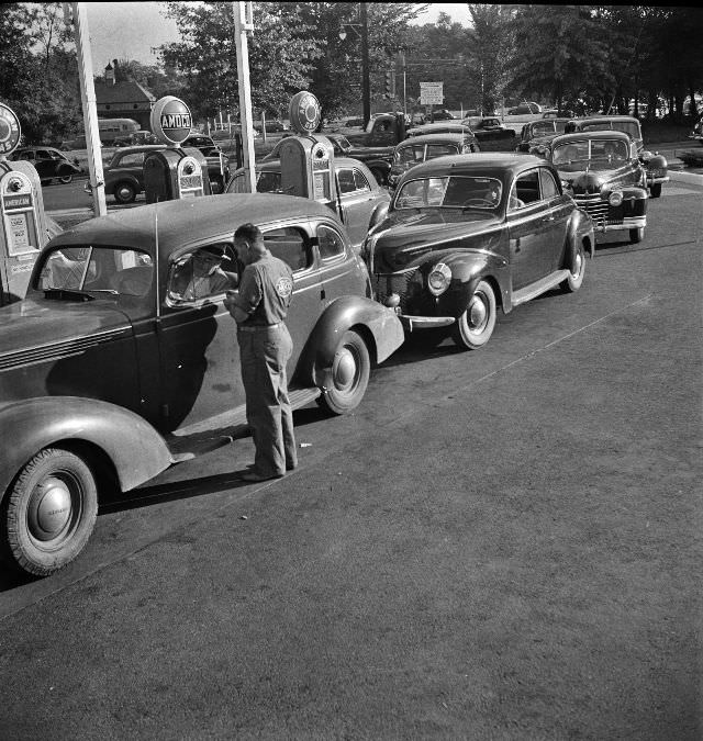 #16 Morning of July 21st, the last day before stricter gas rationing went into effect, cars were parked in front of gas stations long before they opened, waiting to fill their tanks, Washington D.C., 1942