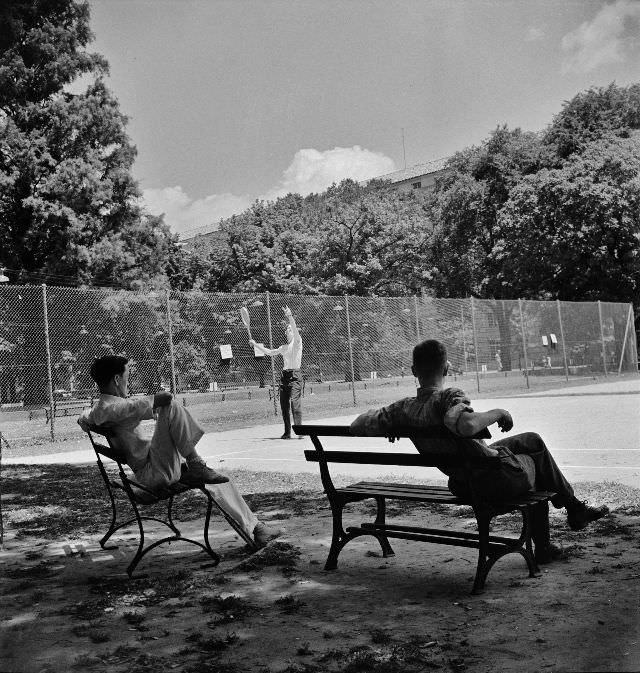 #21 Playing tennis in the park in front of the U.S. Department of Commerce building on Sunday afternoon, Washington, D.C., June 1942