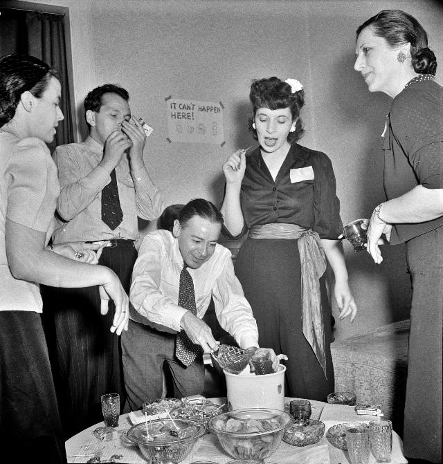 #25 Serving punch during an evening party at the home of a government artist, Washington, D.C. June, 1942