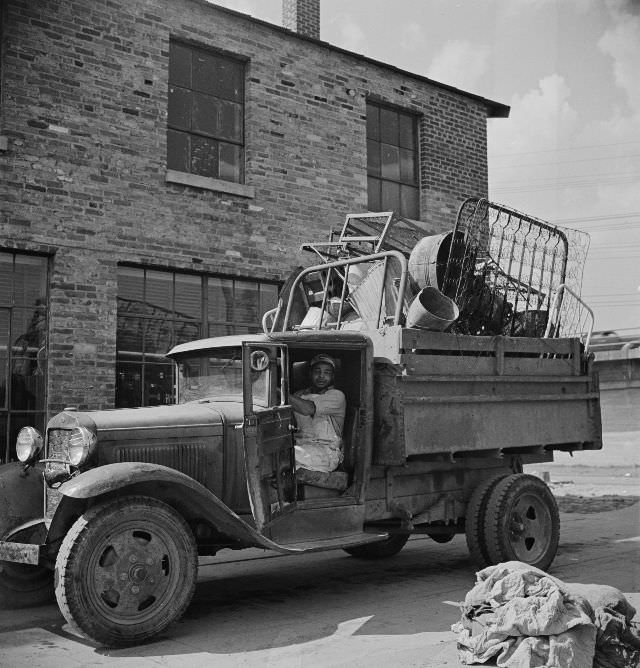#34 Truck loaded with scrap metal is weighed on platform scale before being unloaded in wholesale junkyard during the salvage campaign, Victory Program, Washington, D.C., May 1942