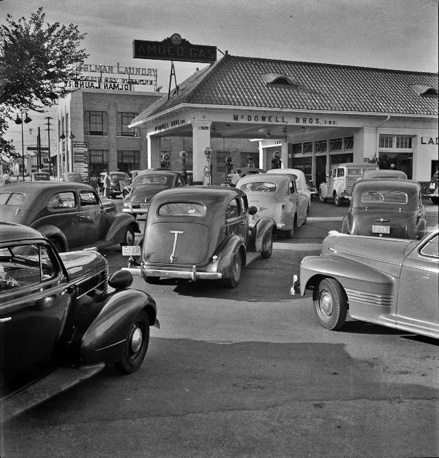 #4 At 7 a.m. on June 21st, the day before stricter gas rationing was enforced, cars were pouring into this gas station on upper Wisconsin Ave., Washington, D.C., 1942