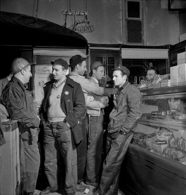 #46 Third shift defense workers waiting in a combination delicatessen and restaurant to be picked up by their car pools around midnight, Baltimore, Maryland, April 1943