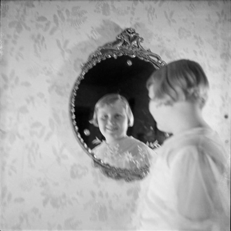 #25 Louise Buckner standing and looking into a mirror