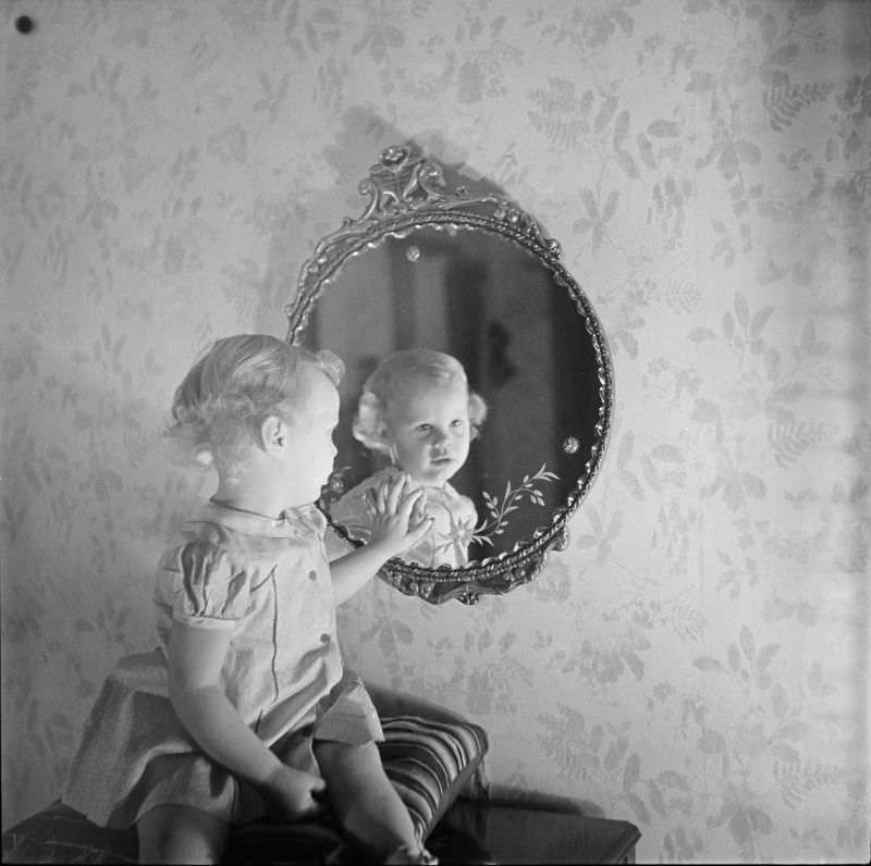 #3 A girl sitting on pillow looking into mirror