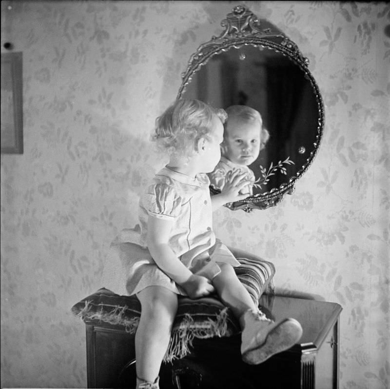 #4 A girl sitting on pillow looking into mirror