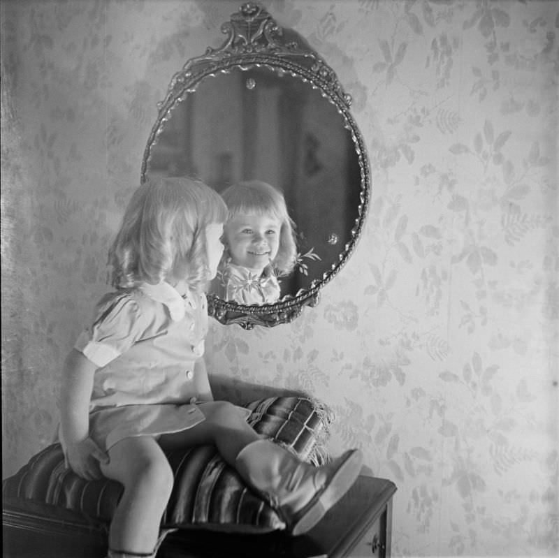 #6 A girl sitting on pillow looking into mirror