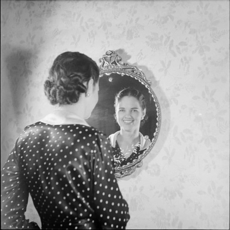 #8 A woman standing and looking into a mirror