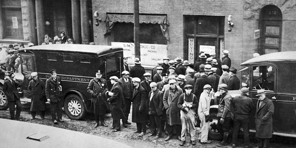 Police and spectators gather in front of the infamous garage where the St. Valentine’s Day Massacre occurred, Chicago 1929.