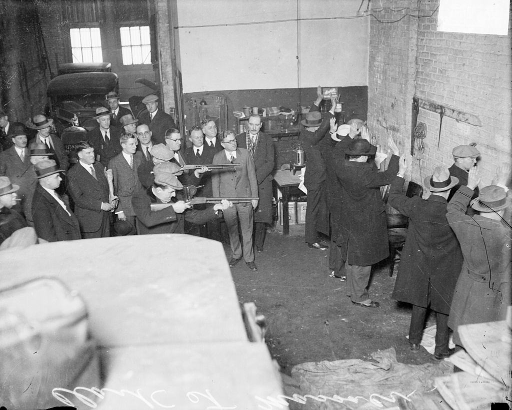 #4 This is a reenactment of the Saint Valentine’s Day Massacre. Dr. Herman N. Bundesen, Cook County Coroner, is standing next to the men holding the guns.
