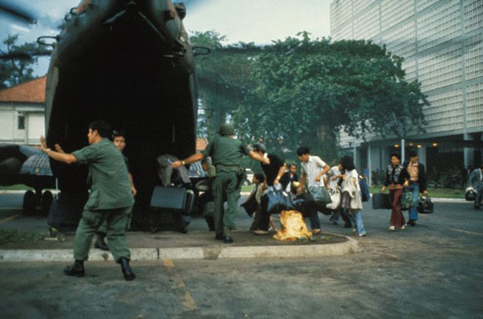 #34 US civilians board helicopter inside the American Embassy compound in Saigon to escape advancing North Vietnamese about to capture Saigon.