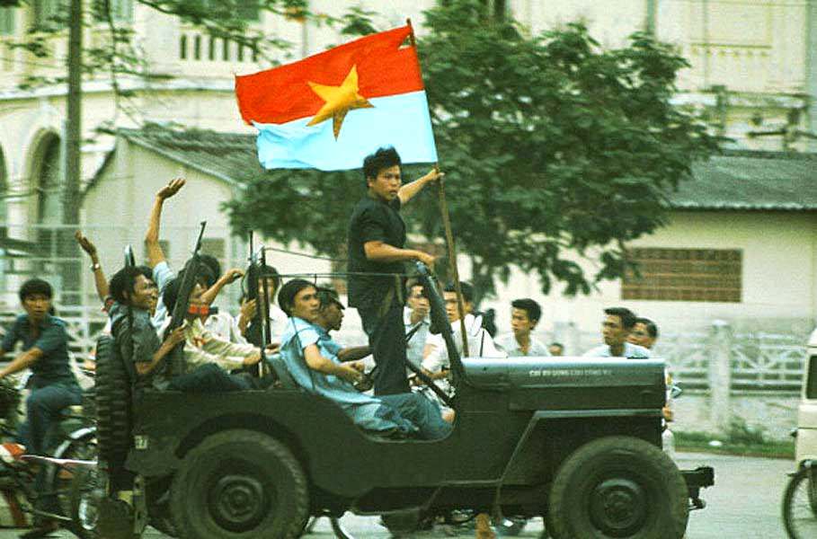 #45 A jeep willis with on board elements of the GRP (Provisional Revolutionary Government) South Vietnamese traverses Saigon announcing the arrival of the north-Vietnamese tanks.