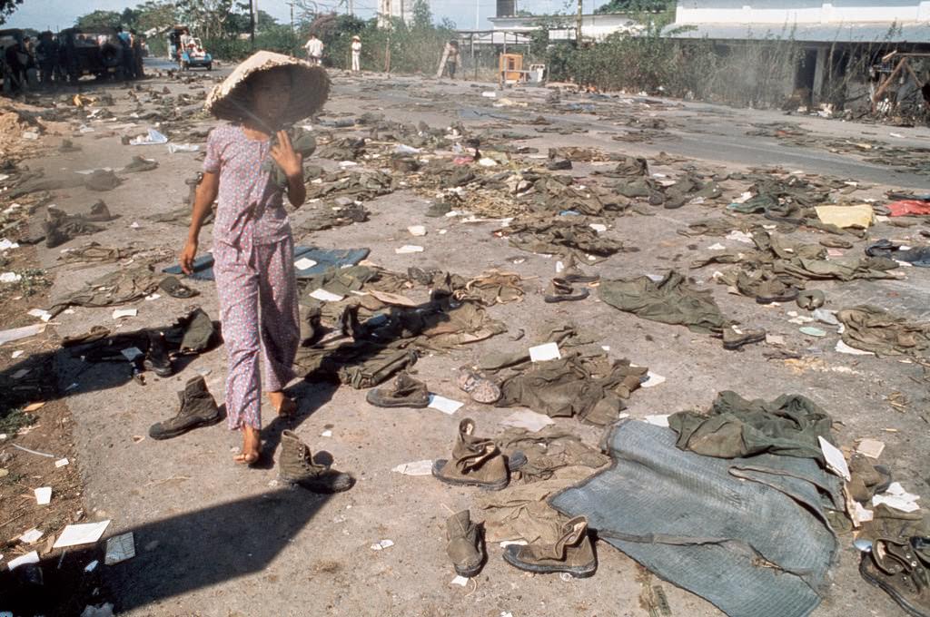 #47 Abandoned uniforms of South Vietnamese soldiers lie on the road after the invasion of North Communist troops which led to the Fall of Saigon.