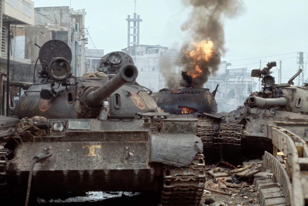 #48 South Vietnamese [sic] tank in flames as North Vietnamese forces enter Saigon.