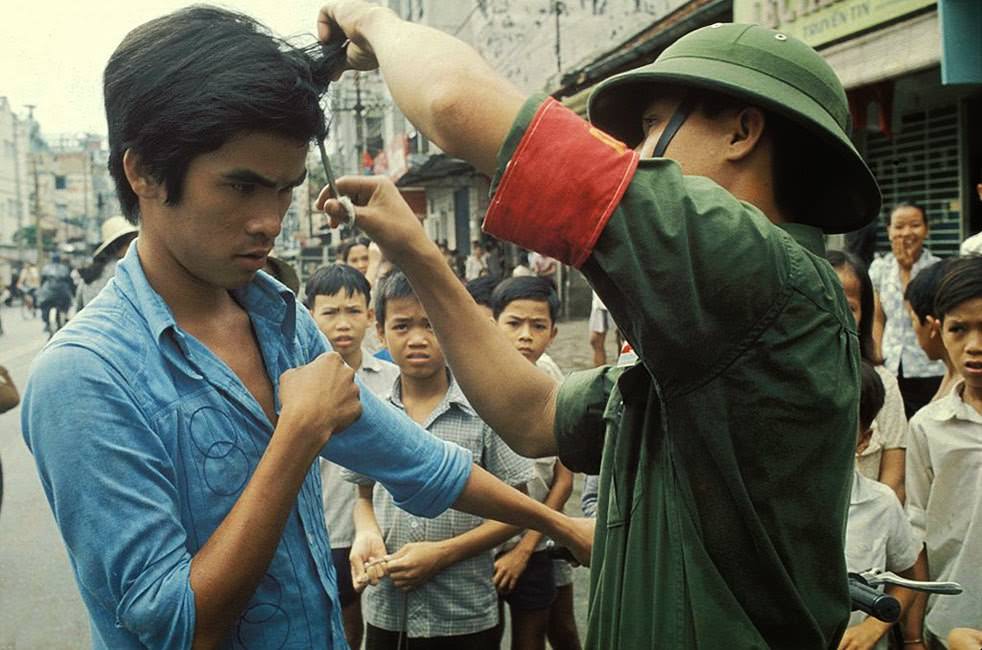 The Vietcong cutting hair and “western” clothes.