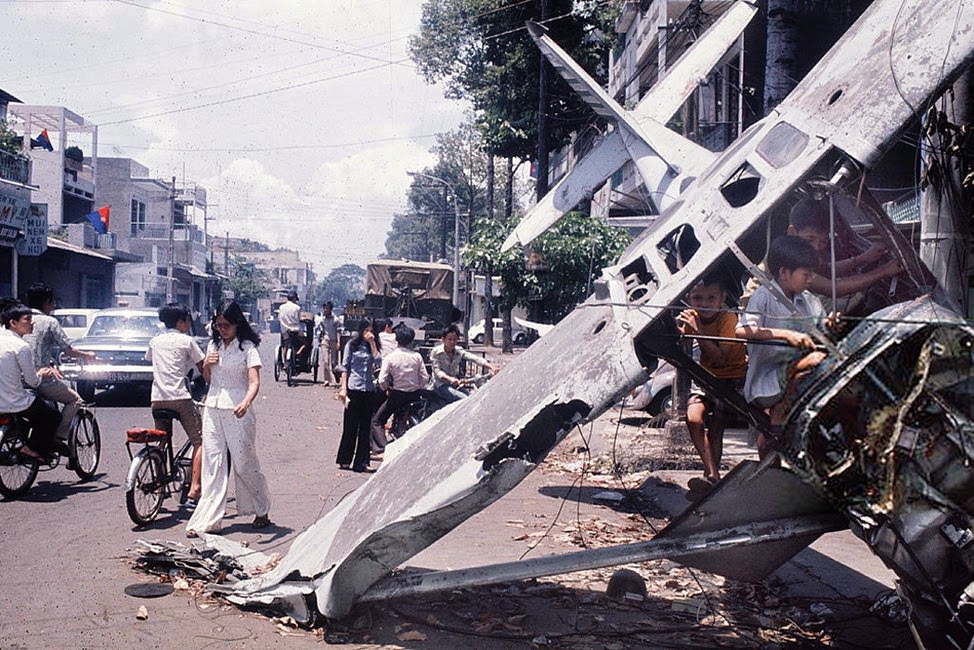 Saigon ( Vietnam’s ) fall. Wreck of an airplane in a street. April 30, 1975.