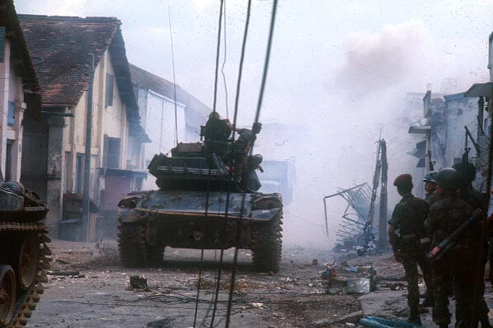 #60 A tank through the streets of the city destroyed, during the Tet offensive, the Vietnamese new year night.