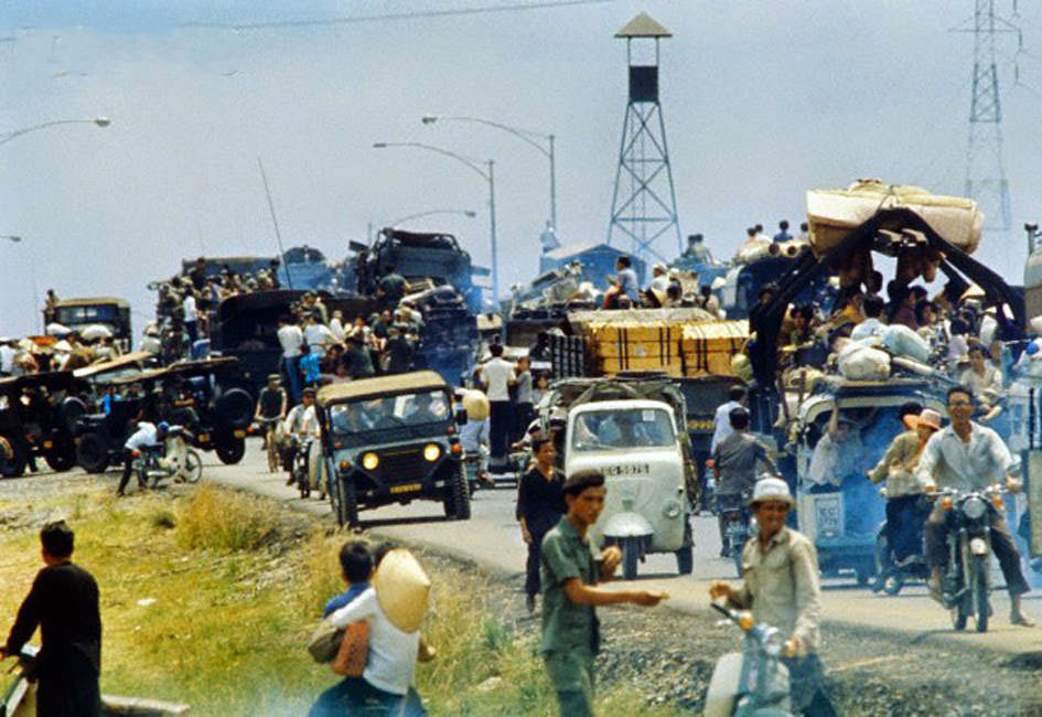Desperate South Vietnamese refugees cling to vehicles along Highway 1.