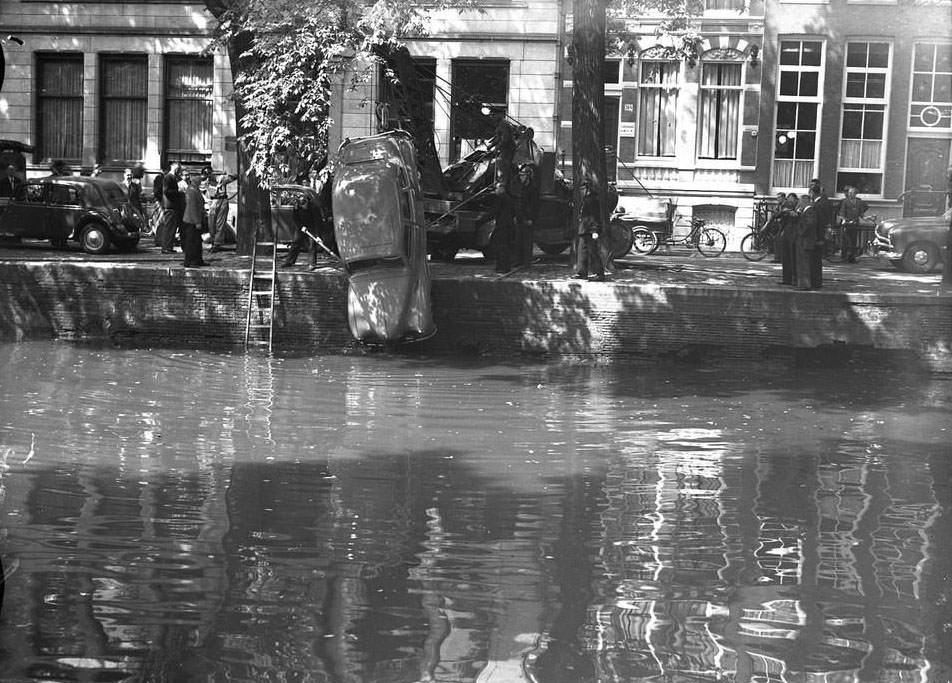 #17 A car being pulled from the canal in Amsterdam, 1940s.